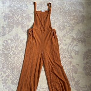Romper/ overalls. Burnt orange. Casual.